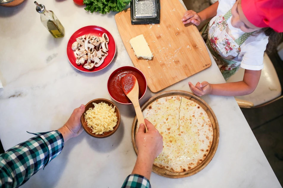 Father and Daughter Preparing Pizza on Kitchen Counter Table, Photo by RDNE Stock Project via Pexels