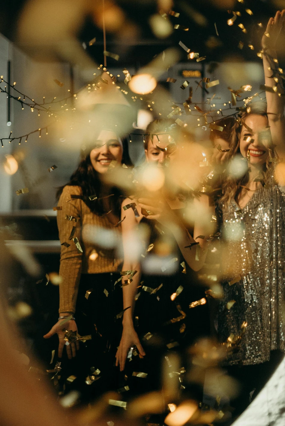 Smiling Women Standing Behind String Lights, Photo by Cottonbro Studio via Pexels