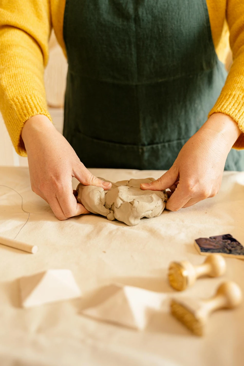 Woman kneading clay, Photo by Antoni Shkraba-Pexels