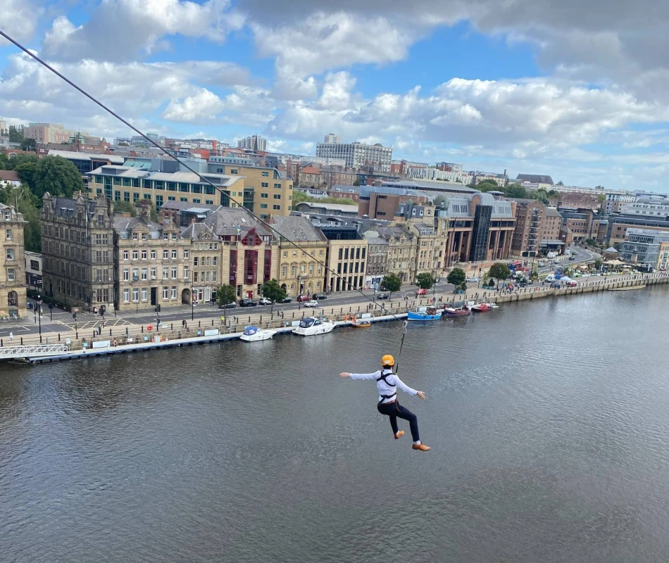 Man ziplining from the Tyne Bridge over the River Tyne